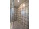 Walk-in shower featuring grey tile and a mosaic floor at 9200 Se 48Th Court Rd, Ocala, FL 34480