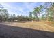 Large backyard with cleared land and trees at 24119 Nw Mallard Ave, Dunnellon, FL 34431