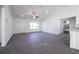 Bright living room with new gray floors, white walls and ceiling fan at 700 Fisher Rd, Ocklawaha, FL 32179