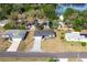 Aerial view of a home in a quiet neighborhood near a lake with mature trees and lush greenery at 781 Ne 130Th Ter, Silver Springs, FL 34488