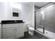 Bathroom featuring a modern vanity with black granite countertops and tiled walk-in shower at 781 Ne 130Th Ter, Silver Springs, FL 34488