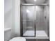 Modern tiled shower with glass doors, rain shower head, and sleek fixtures at 781 Ne 130Th Ter, Silver Springs, FL 34488
