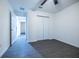 Bright bedroom with double door closet, and modern gray wood-look flooring at 781 Ne 130Th Ter, Silver Springs, FL 34488