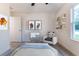 Bedroom with light-blue bedding, window, and panda chair at 781 Ne 130Th Ter, Silver Springs, FL 34488