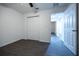 Bedroom with dark laminate floors features a closet and an open doorway at 781 Ne 130Th Ter, Silver Springs, FL 34488