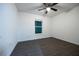 This bedroom features dark laminate flooring and a window allowing natural light at 781 Ne 130Th Ter, Silver Springs, FL 34488