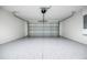 Clean, spacious garage with epoxy flooring and an automatic door opener at 781 Ne 130Th Ter, Silver Springs, FL 34488