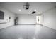 Spacious garage features painted floor, water heater, door to inside, and an opener at 781 Ne 130Th Ter, Silver Springs, FL 34488