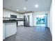 Bright kitchen features stainless steel appliances, white cabinets, and a sliding glass door to the backyard at 781 Ne 130Th Ter, Silver Springs, FL 34488