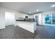 Bright kitchen with white cabinets, stainless steel appliances, granite countertops, and gray wood look flooring at 781 Ne 130Th Ter, Silver Springs, FL 34488
