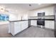 Modern kitchen featuring stainless steel appliances, granite countertops, and white cabinetry at 781 Ne 130Th Ter, Silver Springs, FL 34488
