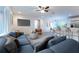 Open living space with a large blue sofa, bar seating, and a modern kitchen at 781 Ne 130Th Ter, Silver Springs, FL 34488