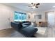 Modern living room with large window and blue sectional providing ample seating at 781 Ne 130Th Ter, Silver Springs, FL 34488