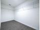 Spacious walk-in closet featuring ample wire shelving and modern gray wood-look flooring at 781 Ne 130Th Ter, Silver Springs, FL 34488