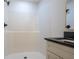 A bathroom with a stand-up shower, granite countertops, and a modern mirror at 1243 Ne 130Th Ter, Silver Springs, FL 34488