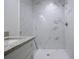 Bathroom featuring a white marble-tiled shower and granite-topped vanity for a luxurious experience at 1243 Ne 130Th Ter, Silver Springs, FL 34488