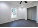 A serene bedroom featuring a window and a closet space with white interior walls and gray wood-look flooring at 1243 Ne 130Th Ter, Silver Springs, FL 34488