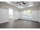 Bright bedroom features a tray ceiling with fan, wood-look flooring, and an ensuite bathroom at 1243 Ne 130Th Ter, Silver Springs, FL 34488