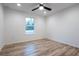 Bright bedroom featuring light wood floors, a ceiling fan, and a window at 1243 Ne 130Th Ter, Silver Springs, FL 34488