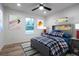 This bedroom with ceiling fan includes a modern color scheme and whimsical wall decor at 1243 Ne 130Th Ter, Silver Springs, FL 34488