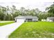 Charming single-story home with attached garage, and a well-manicured lawn at 1243 Ne 130Th Ter, Silver Springs, FL 34488