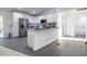 Bright kitchen featuring white cabinets, an island with granite countertops, and stainless steel appliances at 1243 Ne 130Th Ter, Silver Springs, FL 34488