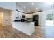 New kitchen with black countertops, white cabinets, stainless steel appliances, and wood-look flooring at 1243 Ne 130Th Ter, Silver Springs, FL 34488