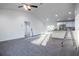 Bright, open-concept living space with gray floors and views of the backyard at 1243 Ne 130Th Ter, Silver Springs, FL 34488