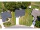 An aerial view reveals a well-maintained residence with a new roof, surrounded by lush greenery and a spacious lot at 13050 Ne 7Th Loop, Silver Springs, FL 34488