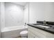 Bathroom featuring a tub, shower, toilet, and vanity with marble tile walls at 13050 Ne 7Th Loop, Silver Springs, FL 34488