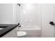 Bathroom with tub, shower, and dark countertop at 13050 Ne 7Th Loop, Silver Springs, FL 34488