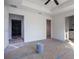 Bedroom featuring a tray ceiling and multiple doorways to other rooms, awaiting finishing touches at 13050 Ne 7Th Loop, Silver Springs, FL 34488