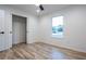 Well-lit bedroom featuring wood-look floors and a window with a view at 13050 Ne 7Th Loop, Silver Springs, FL 34488