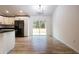 Bright dining room features wood-look floors and sliding glass doors to the backyard at 13050 Ne 7Th Loop, Silver Springs, FL 34488