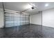 Clean garage with epoxy floor and a metal sectional door at 13050 Ne 7Th Loop, Silver Springs, FL 34488