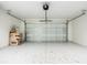 Spacious garage with a large door, epoxy flooring, and ample room for parking and storage at 13050 Ne 7Th Loop, Silver Springs, FL 34488