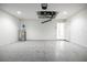 Clean garage space with speckled epoxy floor, water heater, and access door to the house at 13050 Ne 7Th Loop, Silver Springs, FL 34488