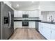Bright kitchen features stainless steel appliances, white cabinets, and granite countertops at 13050 Ne 7Th Loop, Silver Springs, FL 34488