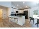 Modern kitchen with white cabinets, black countertops, and stainless steel appliances at 13050 Ne 7Th Loop, Silver Springs, FL 34488