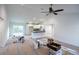 Spacious living area with vaulted ceilings, natural light, and seamless transition to the kitchen area, ideal for gatherings at 13050 Ne 7Th Loop, Silver Springs, FL 34488