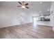 Spacious living room featuring vaulted ceilings, wood-look floors, and an open floor plan at 13050 Ne 7Th Loop, Silver Springs, FL 34488