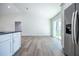 Open-concept living room and kitchen area with stainless steel refrigerator at 13050 Ne 7Th Loop, Silver Springs, FL 34488