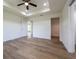 A well-lit main bedroom with a ceiling fan, access to a walk-in closet, and an ensuite bathroom at 13050 Ne 7Th Loop, Silver Springs, FL 34488