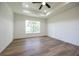 Bright and airy main bedroom with large window, ceiling fan and tray ceiling at 13050 Ne 7Th Loop, Silver Springs, FL 34488