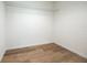 Walk-in closet with a wire shelf and wood flooring at 13050 Ne 7Th Loop, Silver Springs, FL 34488
