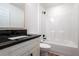 Modern bathroom with dark countertop and shower/tub combo at 600 Ne 130Th Ter, Silver Springs, FL 34488