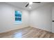 Simple bedroom with wood-look floors and a window at 600 Ne 130Th Ter, Silver Springs, FL 34488