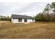 Back of house, featuring a large yard and sliding glass doors at 600 Ne 130Th Ter, Silver Springs, FL 34488