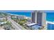 Aerial view of the condo building with beach and ocean views from multiple units at 89 S Atlantic Ave # 204, Ormond Beach, FL 32176
