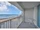 Balcony with ocean view and small table at 89 S Atlantic Ave # 204, Ormond Beach, FL 32176